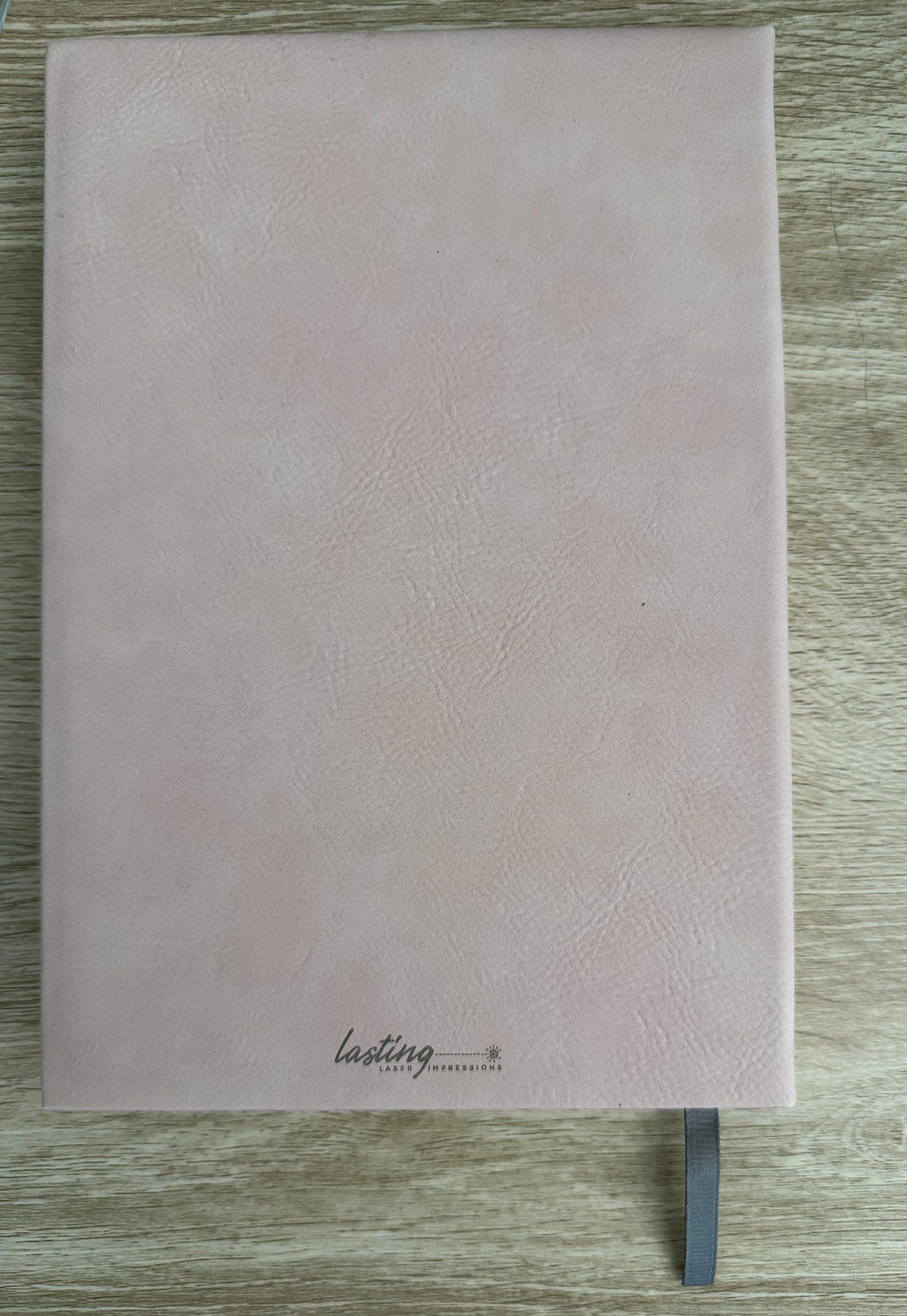 Dusty pink notebook with gold logo